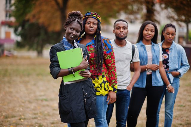 Row of group five african college students spending time togethe